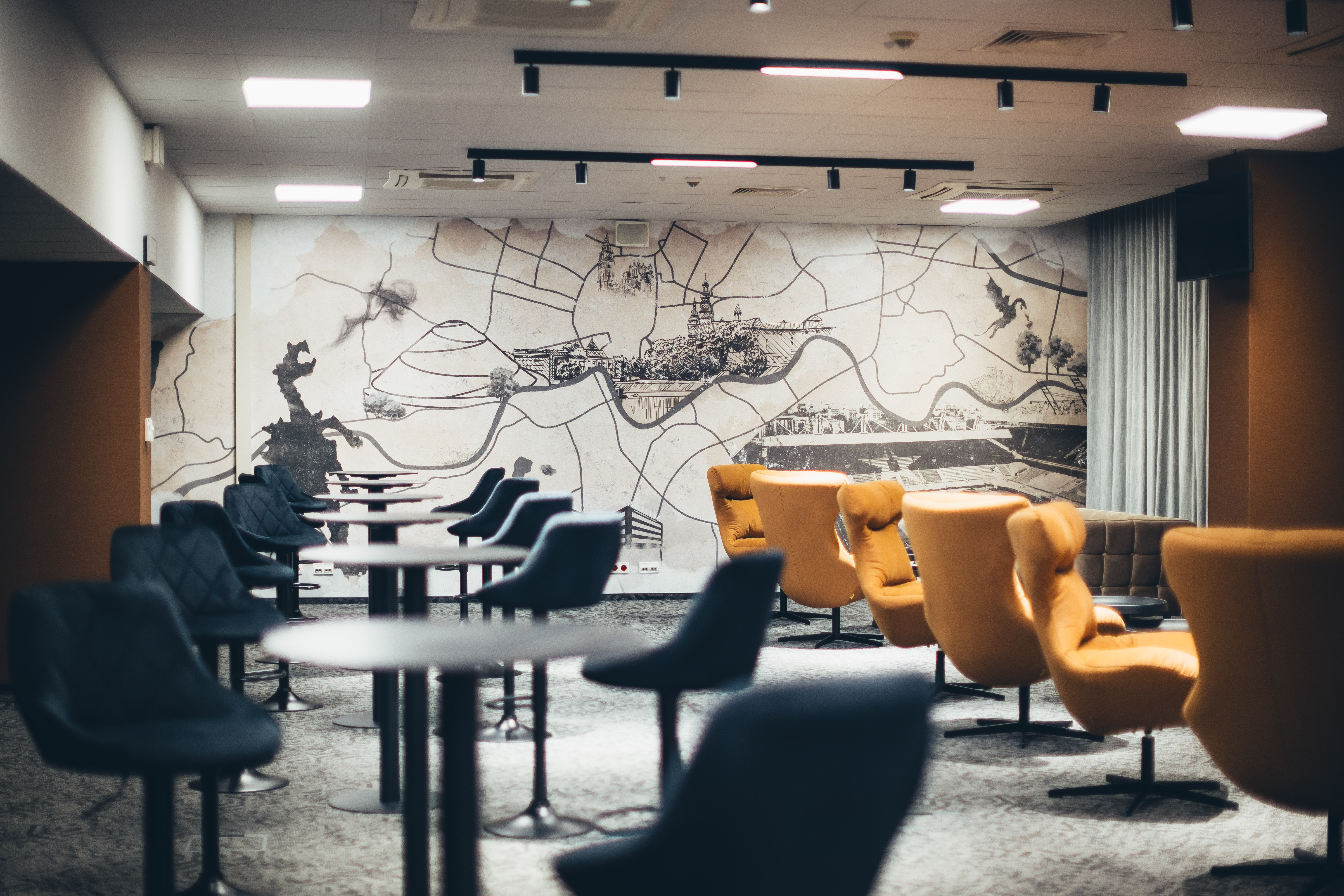 VIP Royal Lounge — wider view with cocktail tables and the Wawel motif on the wall